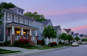 a row of beautiful houses managed by Riverside Association Management, pictured at sunset